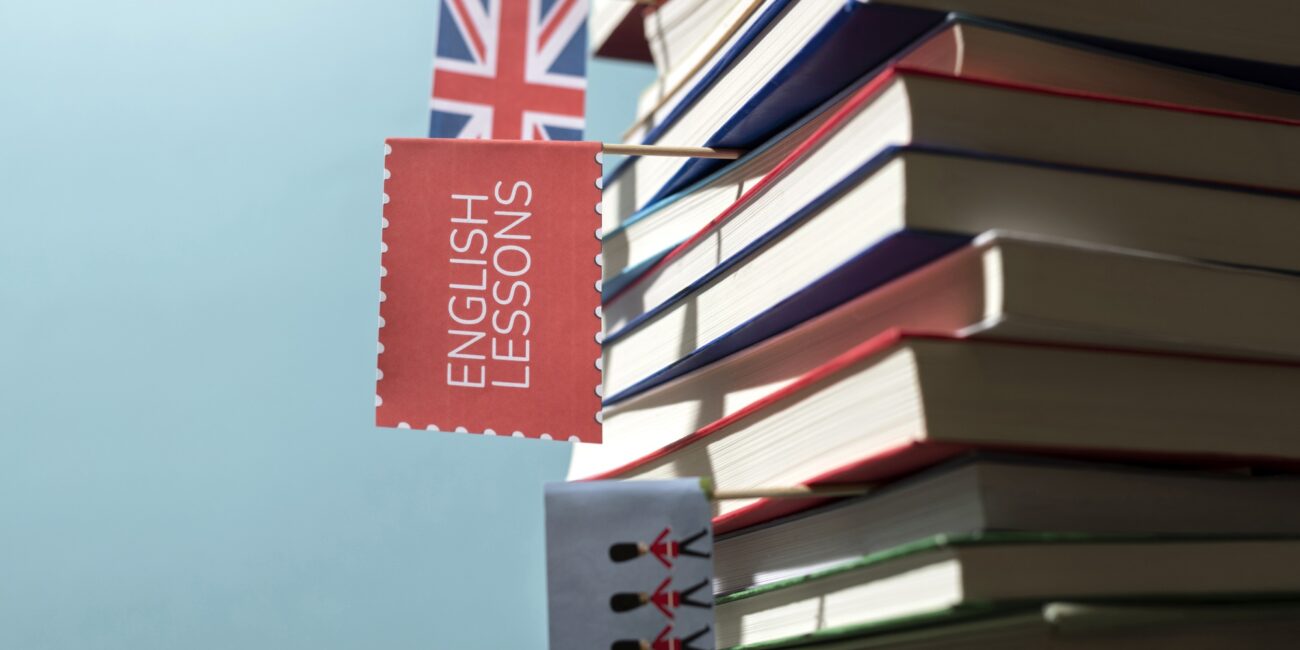Cursos de inglés con profesor nativo english books stacks table working space 1